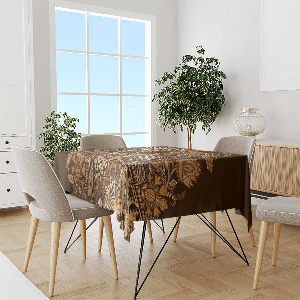 Gold and brown paisley shuka tablecloth across dining table with chairs