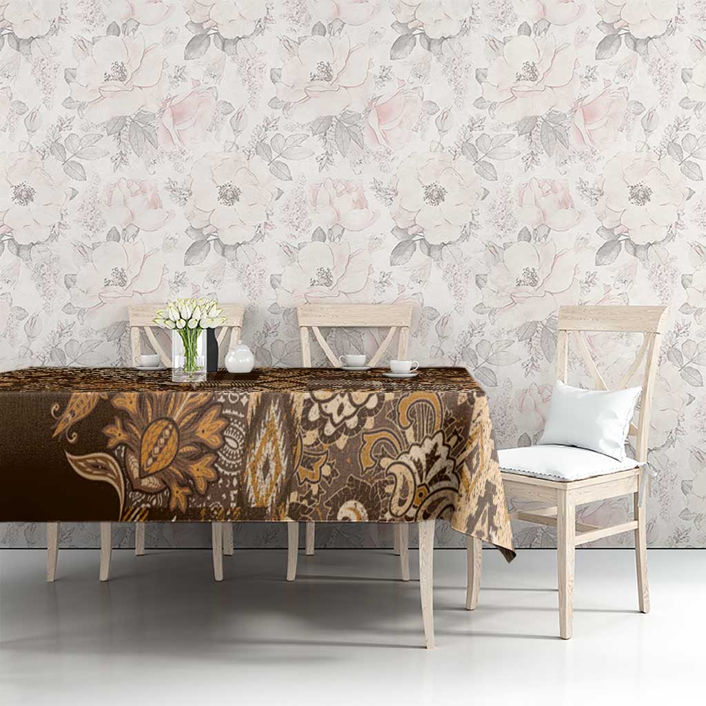 Gold and brown floral shuka tablecloth on long table with vase centerpiece