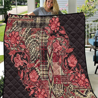 Red and black quilt with paisley floral print and quilted diamond stitching