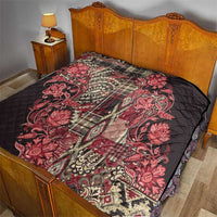 Red floral paisley quilt covering a bed, quilted black backing