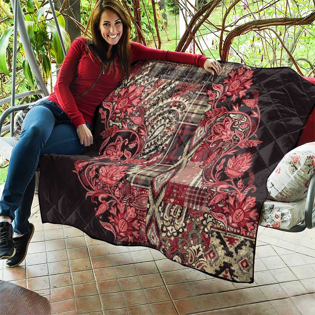 Large red and black quilt with paisley floral print, quilted diamond stitching