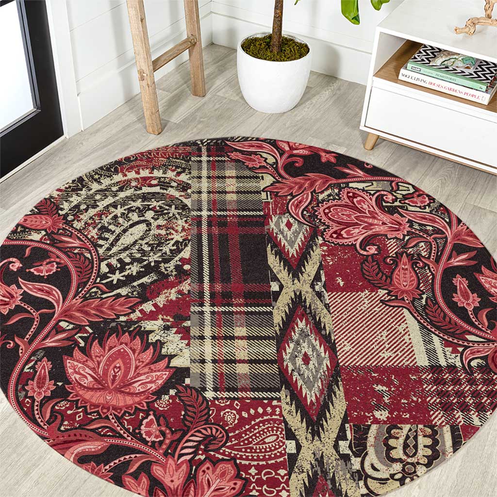 Red round rug with floral paisley print, plaid block center, and decorative geometric edging
