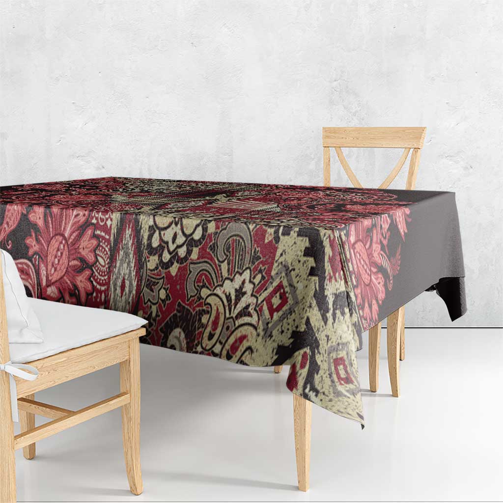 Red and black floral patchwork tablecloth draped over a rectangular table.