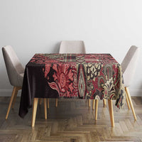 Red, black, and cream paisley floral tablecloth with block-pattern border.