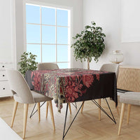 Floral patchwork tablecloth with red tones and dark accents, covering a dining table.