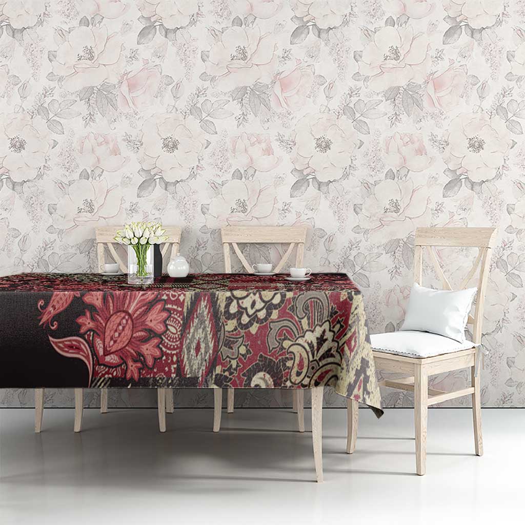 Red and black floral Maasai shuka tablecloth with cream medallion motifs.