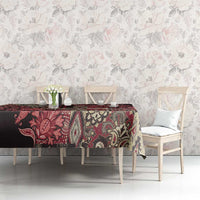 Red and black floral Maasai shuka tablecloth with cream medallion motifs.