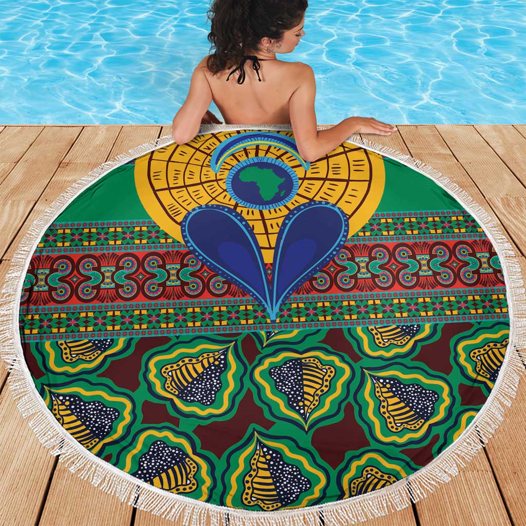 Round green kanga blanket with ornate central sun/eye design and tassel fringe