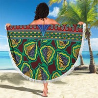 Round green kanga blanket with central motif and tassel-fringed edge