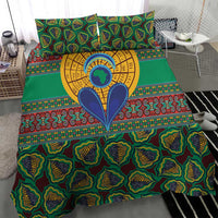 Green kanga-style bedding set with bold tribal motif and yellow circular center