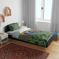 Green kanga-style bedding set on bed with matching pillows and tribal artwork