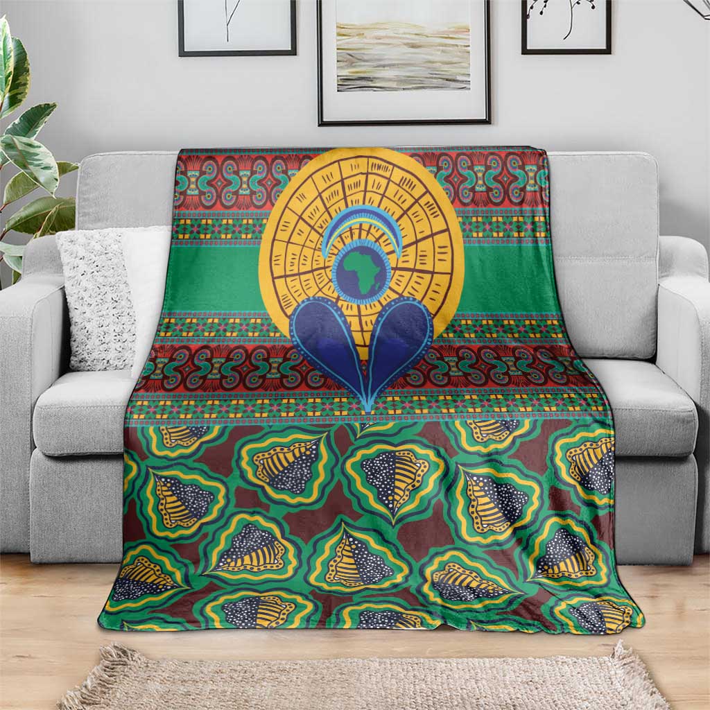 Green African pattern throw blanket draped over a sofa; colorful tribal shapes and circular design