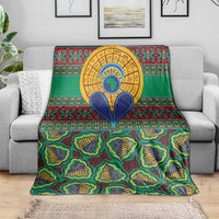 Green African pattern throw blanket draped over a sofa; colorful tribal shapes and circular design
