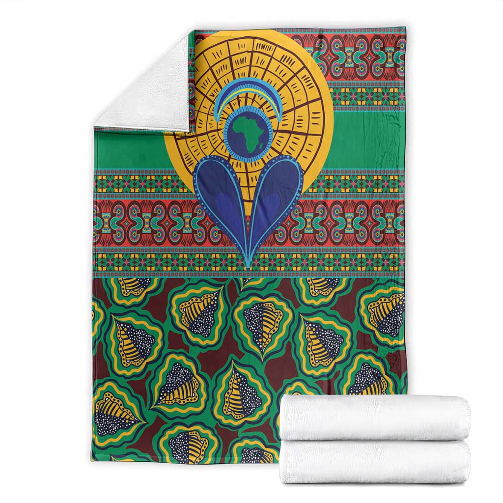 Green African pattern blanket folded with gold circular center and blue heart-shaped motif