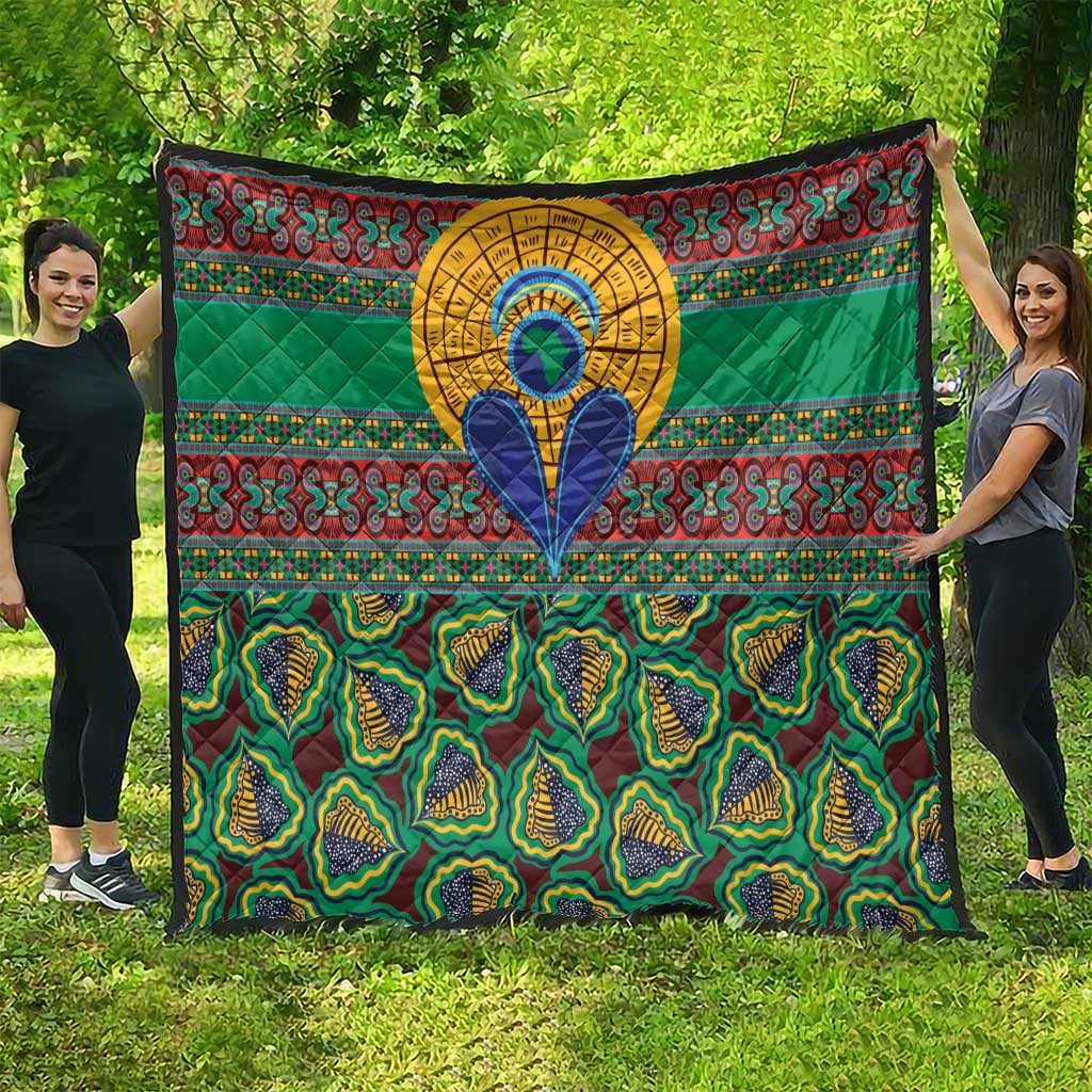 Green traditional kanga-style quilt with geometric bands, central blue figure, and patterned bottom