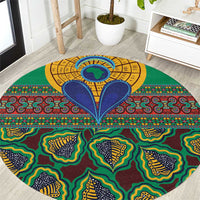 Close-up green round rug with yellow center medallion and bold multicolor kanga pattern