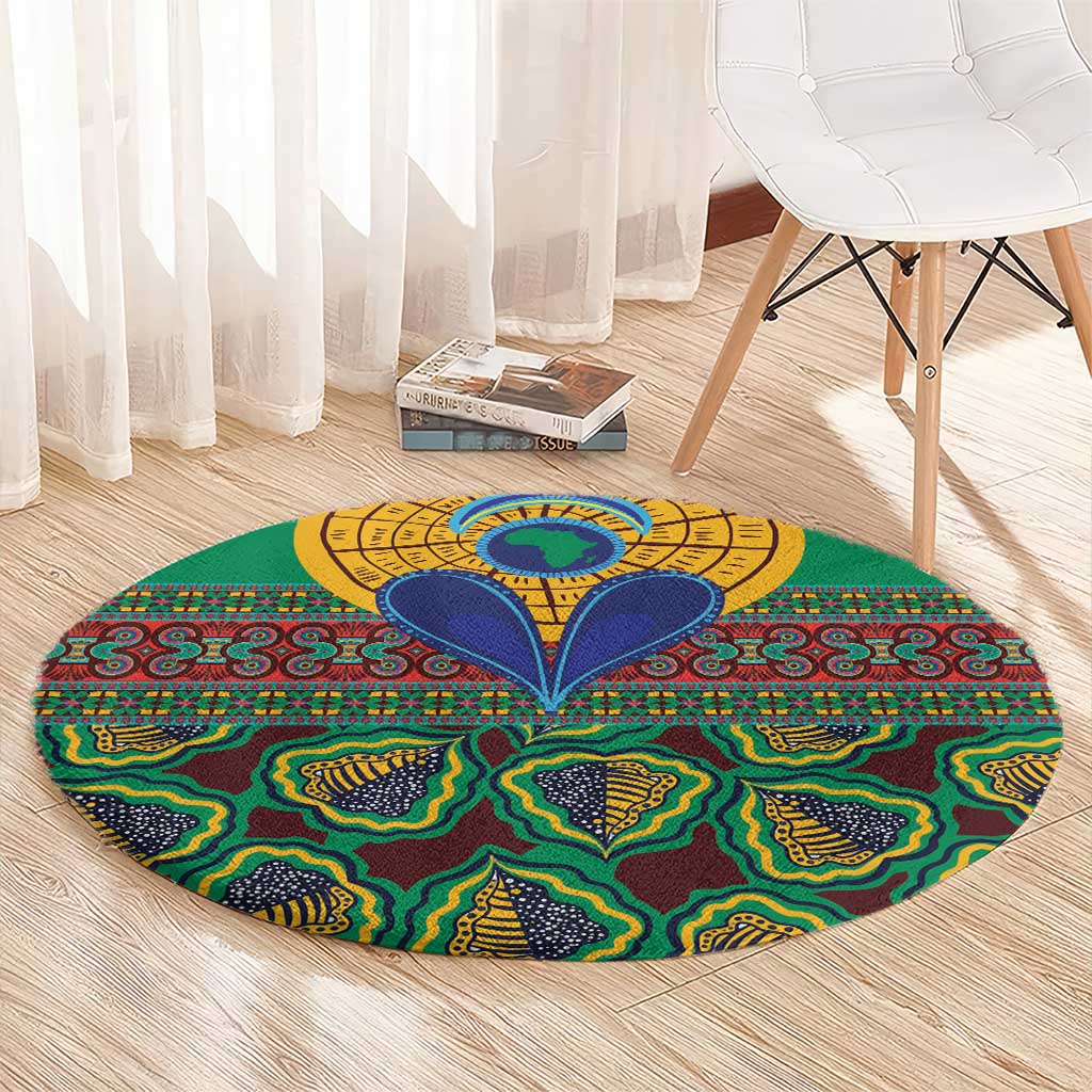 Green round rug with colorful geometric kanga pattern, yellow circular center, and blue accents