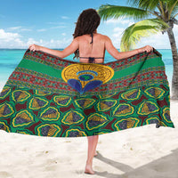 Green kanga-style sarong with large blue-yellow medallion and repeating swirl patterns