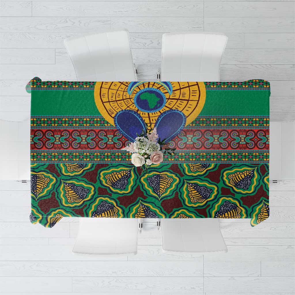 Green tablecloth flat lay with bold circular and geometric African pattern motifs