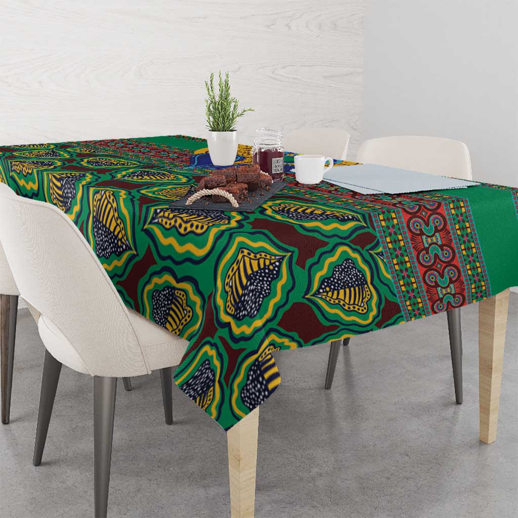 Green African pattern tablecloth on dining table with cups and decor on top