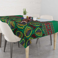 Green African pattern tablecloth on dining table with cups and decor on top