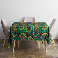 Green geometric African pattern tablecloth on a small dining table with four chairs