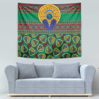 Green African kanga tapestry with central emblem and rows of detailed teardrop motifs