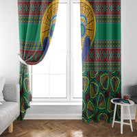 Green kanga-style curtain panels framing a white door and window, side draped view