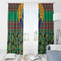 Green kanga-style window curtain panels with border bands and partial sheer curtain setup