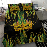 Feather mask Mardi Gras bedding set: black bedding with large gold mask, green peacock feathers, 2 pillows
