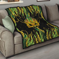 Feather mask Mardi Gras quilt draped on sofa, black with green-yellow feathers and gold mask