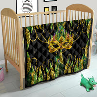 Feather mask Mardi Gras quilt over crib, black with gold mask and peacock feather pattern