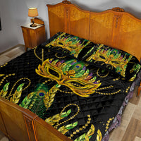 Black quilt bed set with bold green feather and gold mask print, styled on a bed with pillows