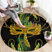 Round black carpet with ornate gold mask and colorful green peacock feathers design