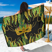 Black and green feather-print sarong with gold chain accents, draped wide