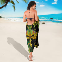 Black and green feather-print sarong with gold motif, tied at back
