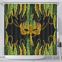 Green shower curtain featuring central feather mask, peacock feather pattern and gold beads