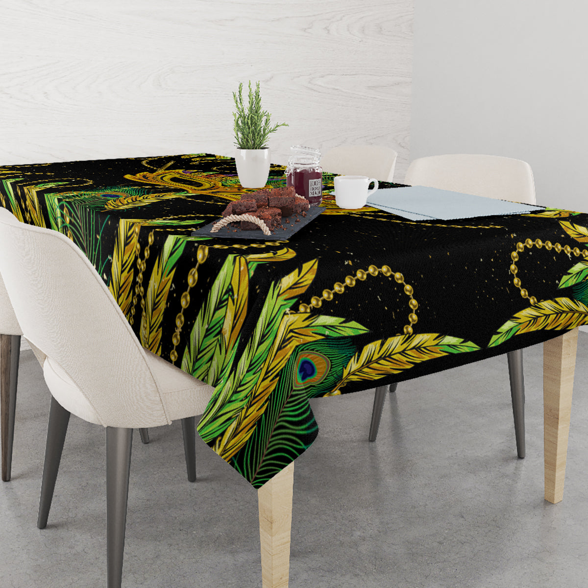 Green and black peacock feather tablecloth with gold bead trim over table