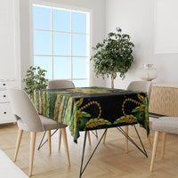 Green peacock feather patterned tablecloth covering dining table surface