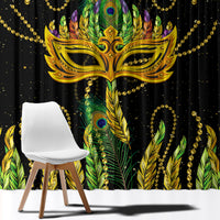 Close-up of green feather-pattern curtain with gold masquerade mask details and beaded accents.