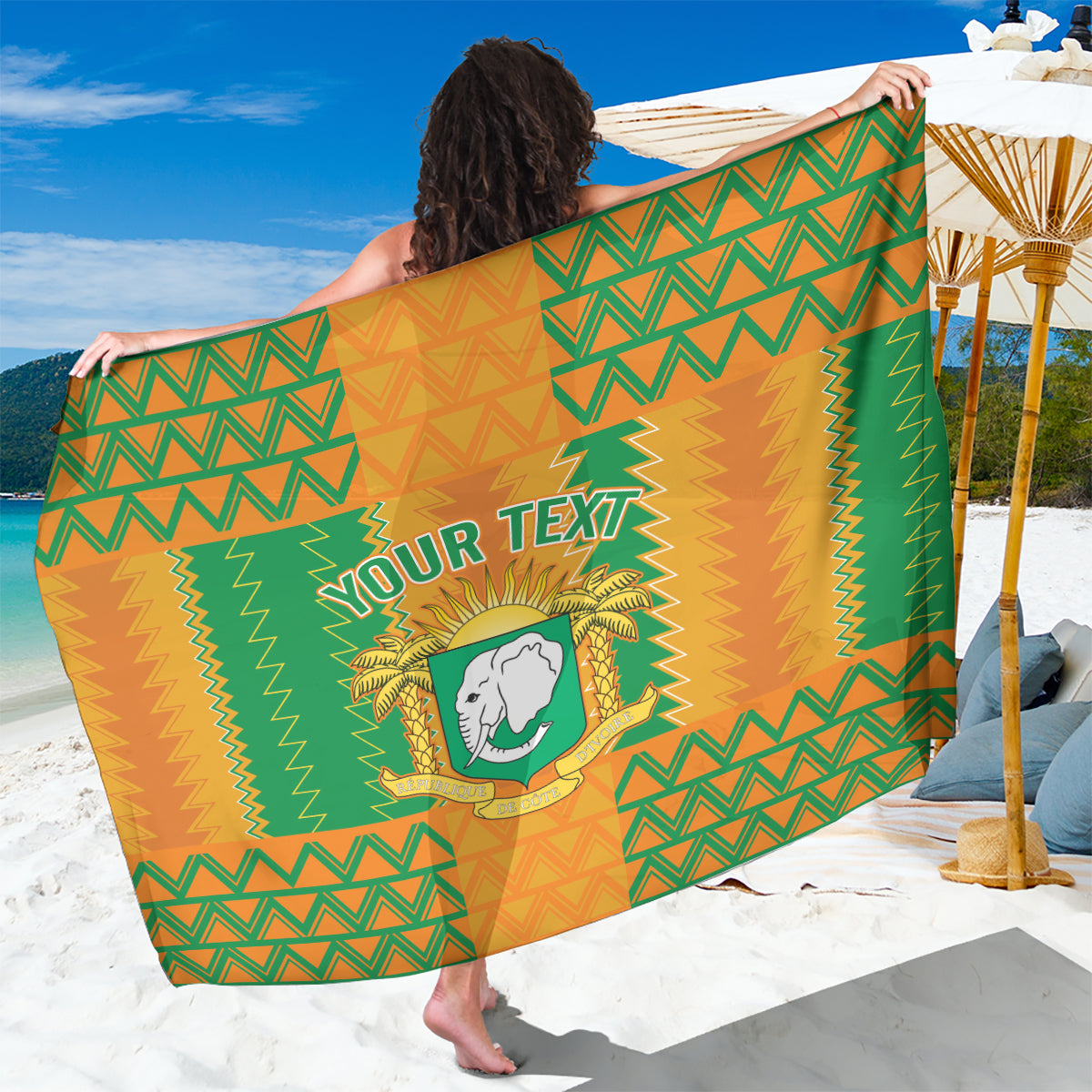 Orange and green football-themed sarong with crest and zigzag pattern, folded
