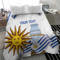 White duvet cover with blue striped flag and sun face; two pillow shams on bed