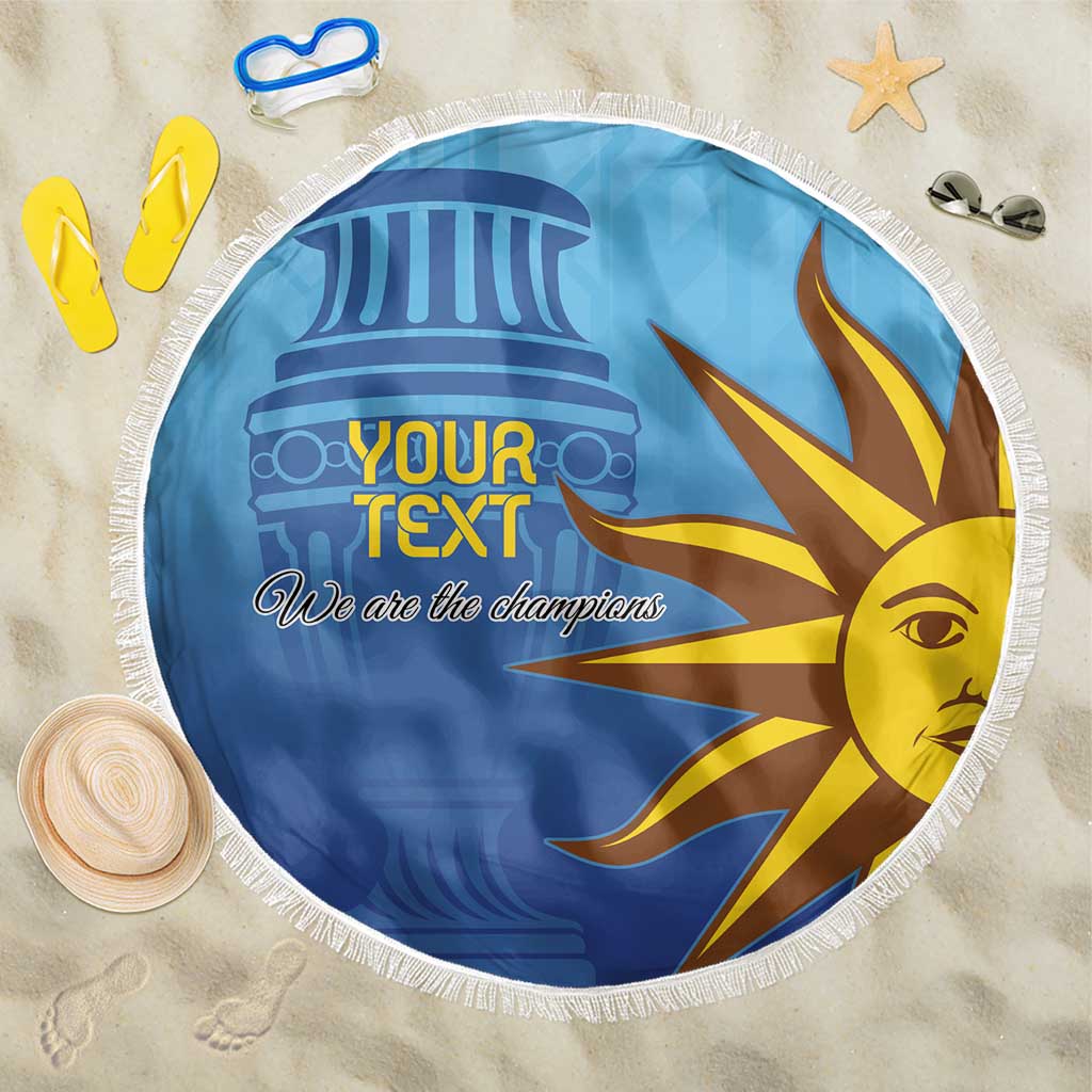 Custom Uruguay beach blanket, round blue-and-yellow sun/eye print with “We are the champions”