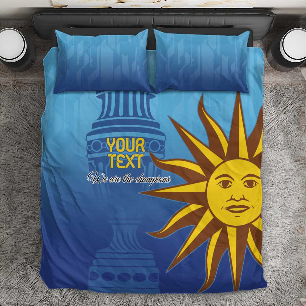 Blue bedding set on floor with yellow sun-face design and 'Your Text' on the duvet