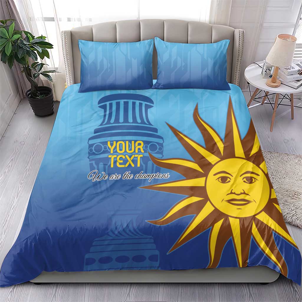 Blue comforter set with yellow sun mascot, 'Your Text' and 'We are the champions'