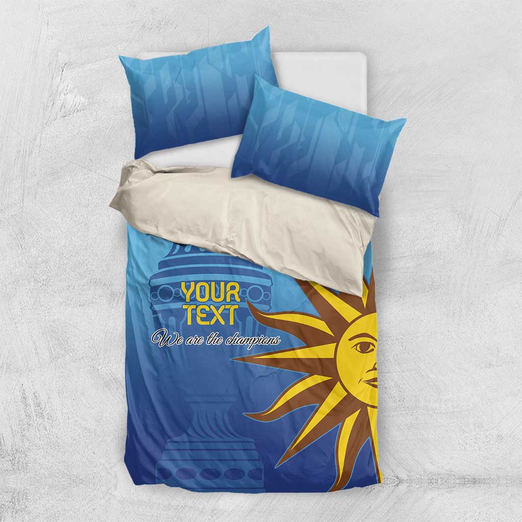 Blue bedding set with gray backing sheet, yellow sun face, and 'Your Text' text