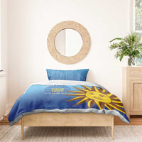 Blue bedding set with yellow sun face graphic and a central comforter panel with pillows