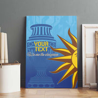 Blue canvas wall art with column and sunburst graphic, custom text, on wooden floor