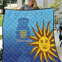 Blue football quilt with custom text and golden sun face graphic, held outdoors