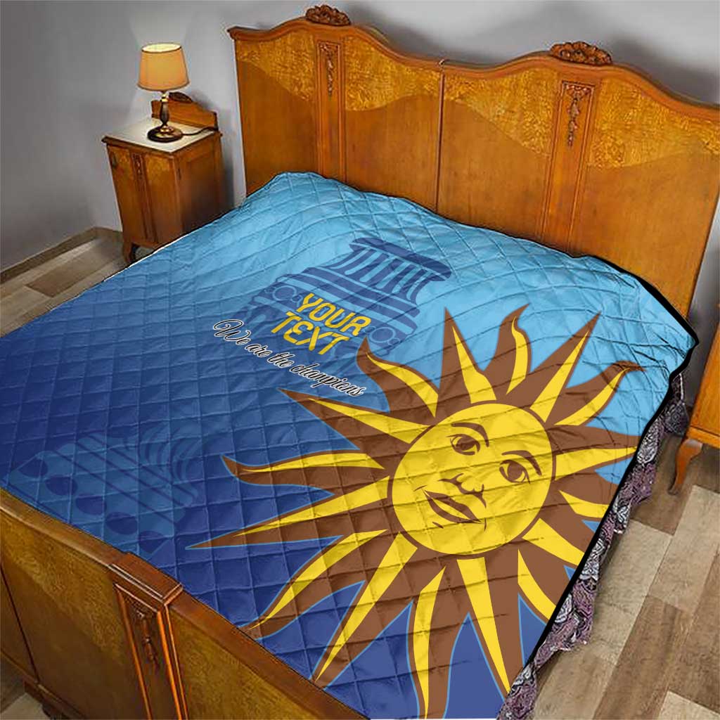 Blue quilt with custom text and golden sun face graphic on bed